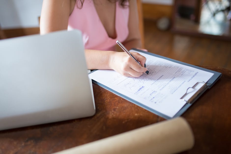 A person focused on learning, sitting at a clean desk with a laptop and a cup of coffee.